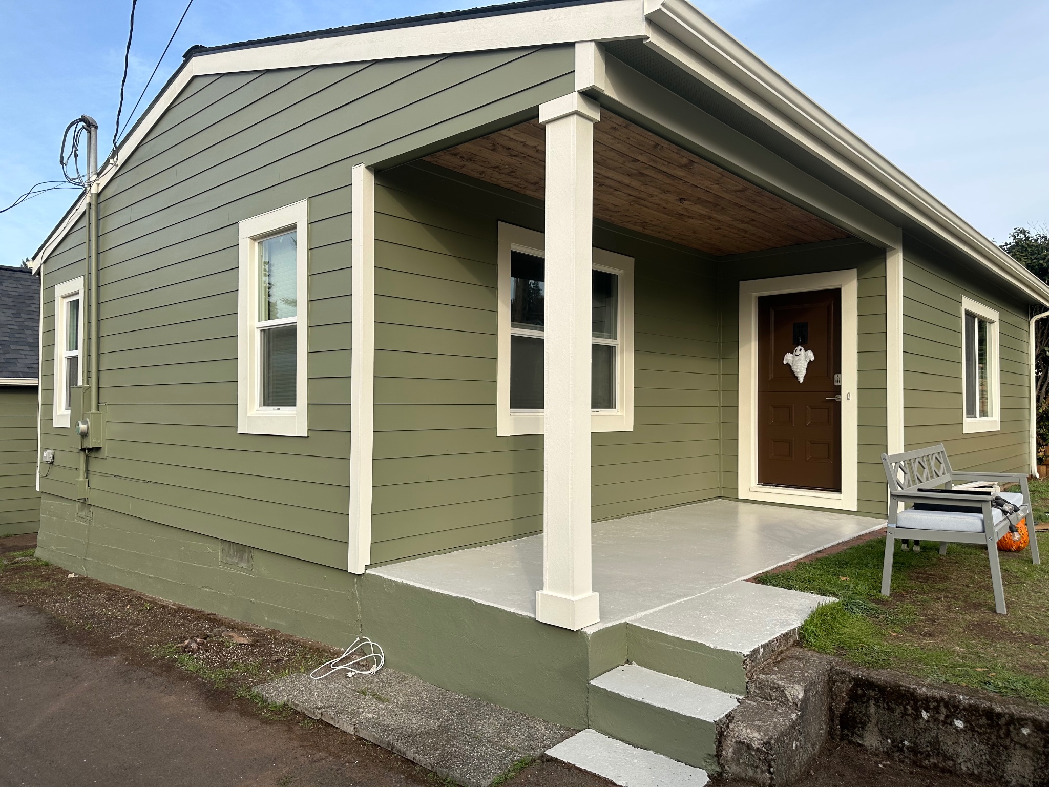Completed James Hardie HardiePlank® siding installation — sage green with white trim by Firu Construction LLC